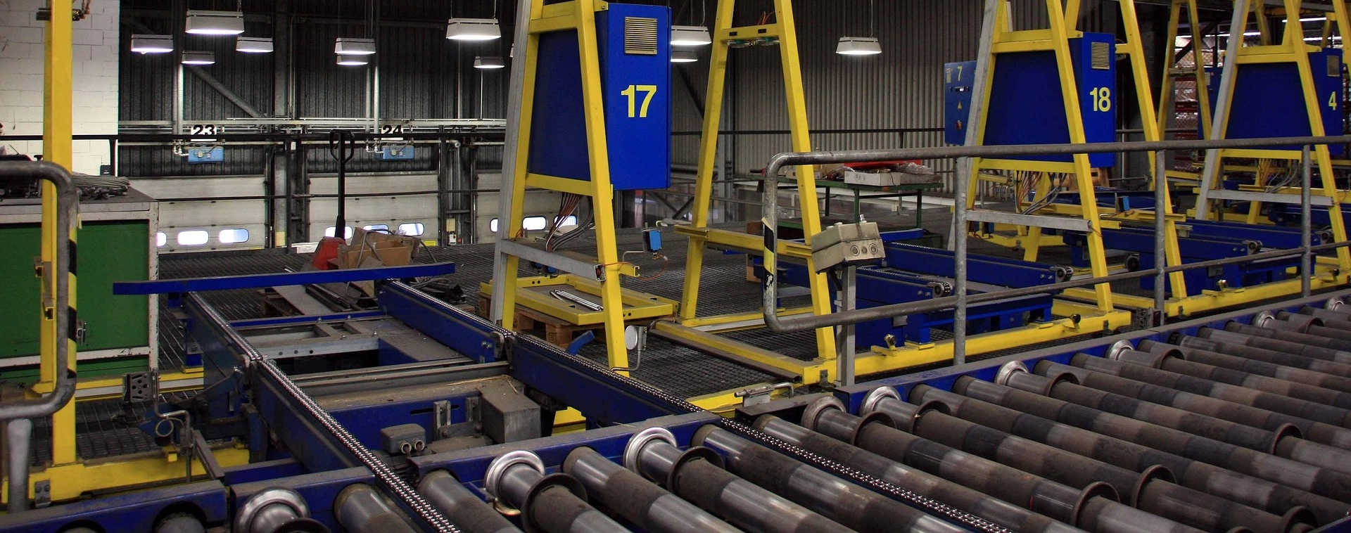 Industrijske valjčne proge z rumeno-modro konstrukcijo in številčno označenimi enotami